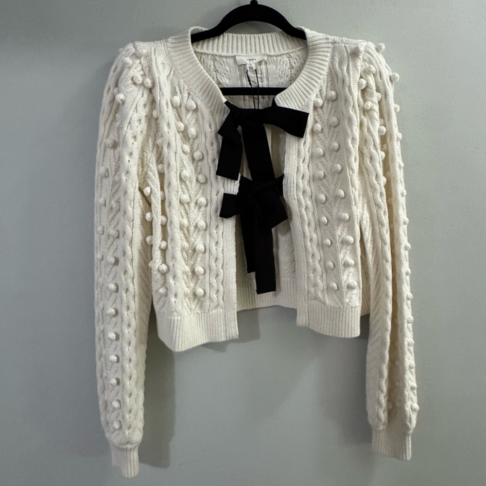 a loves a White Knit Sweater with Black Bows